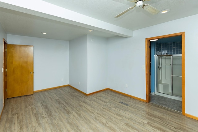 spare room with hardwood / wood-style flooring and ceiling fan