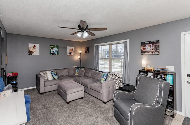 living room with ceiling fan, carpet floors, and a textured ceiling