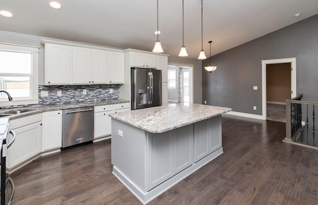 kitchen with white cabinets, a kitchen island, and appliances with stainless steel finishes