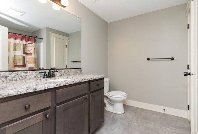 bathroom featuring tile patterned floors, vanity, and toilet