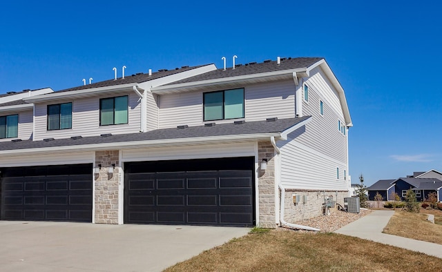 view of front of house featuring cooling unit and a garage