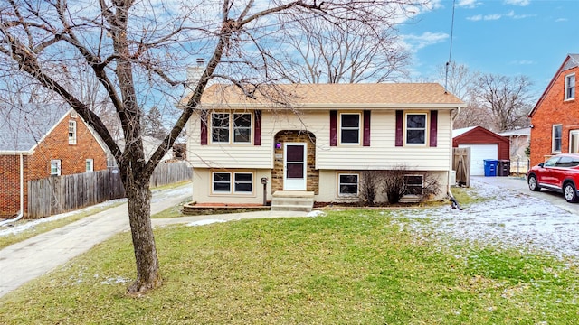 bi-level home with an outbuilding and a front lawn