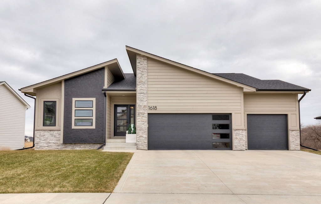 view of front of home with a front yard and a garage