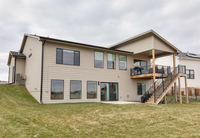 rear view of property featuring a yard and a patio