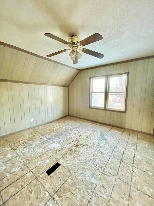 additional living space with ceiling fan and lofted ceiling