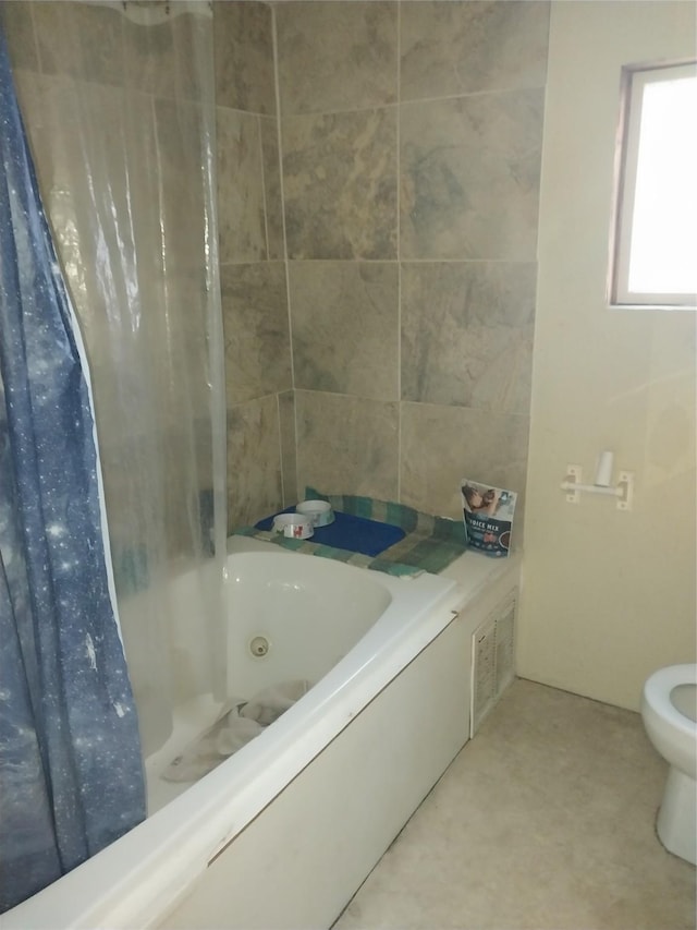 bathroom featuring toilet and shower / bathtub combination with curtain