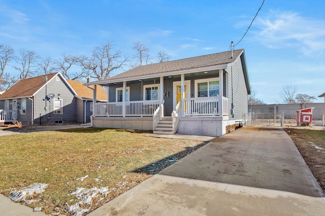 bungalow-style house featuring a front lawn and covered porch