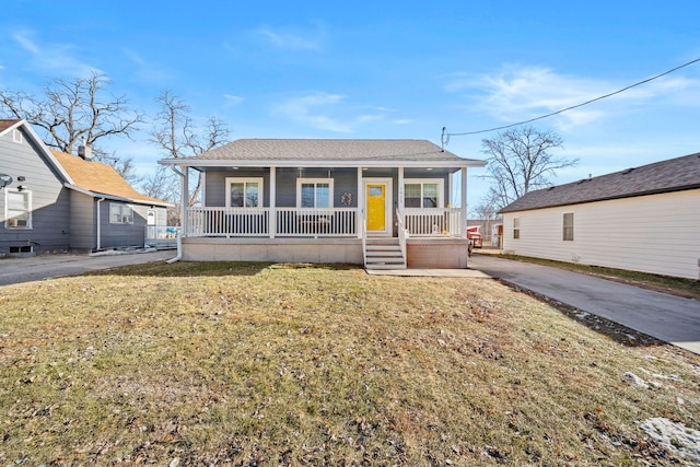 bungalow-style house with covered porch and a front yard