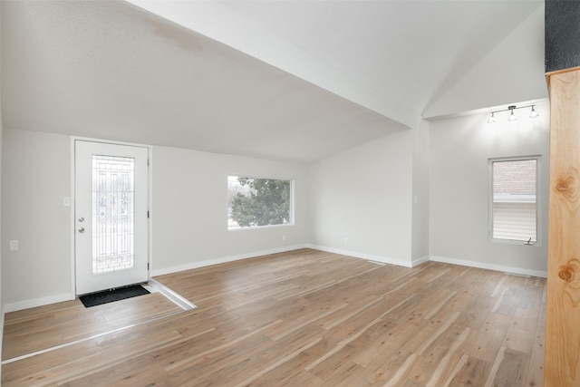 interior space featuring light hardwood / wood-style flooring and lofted ceiling