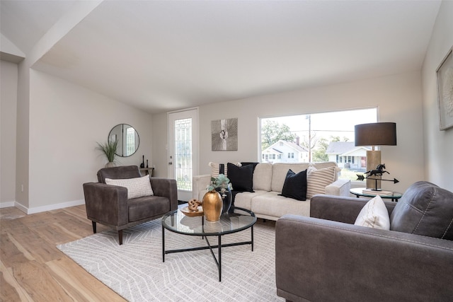 1141 Euclid Ave, Des Moines, IA 50313 - living room with light wood-type flooring, baseboards, and vaulted ceiling