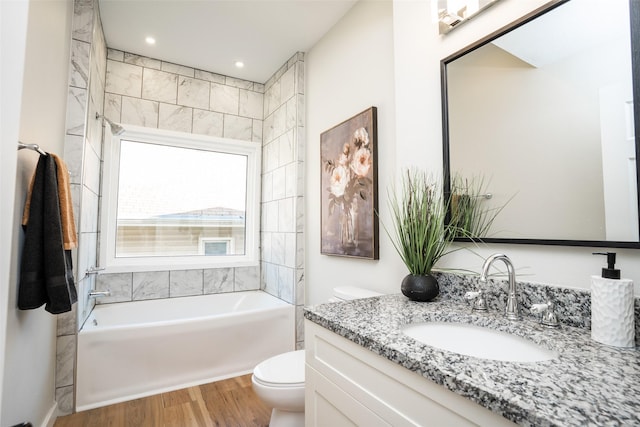 1141 Euclid Ave, Des Moines, IA 50313 - full bath featuring toilet, wood finished floors, vanity, a bathtub, and recessed lighting
