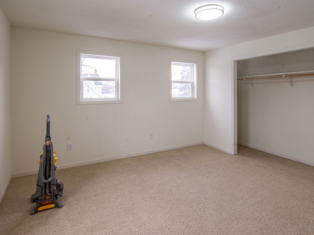 unfurnished bedroom featuring carpet and a closet