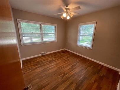 empty room featuring ceiling fan and dark hardwood / wood-style flooring