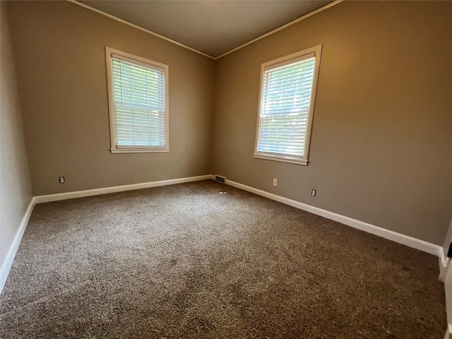 carpeted empty room featuring ornamental molding