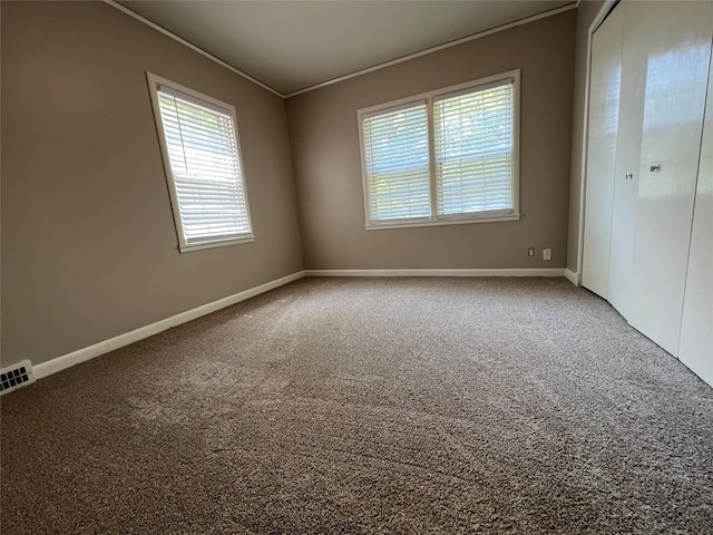 carpeted spare room with crown molding