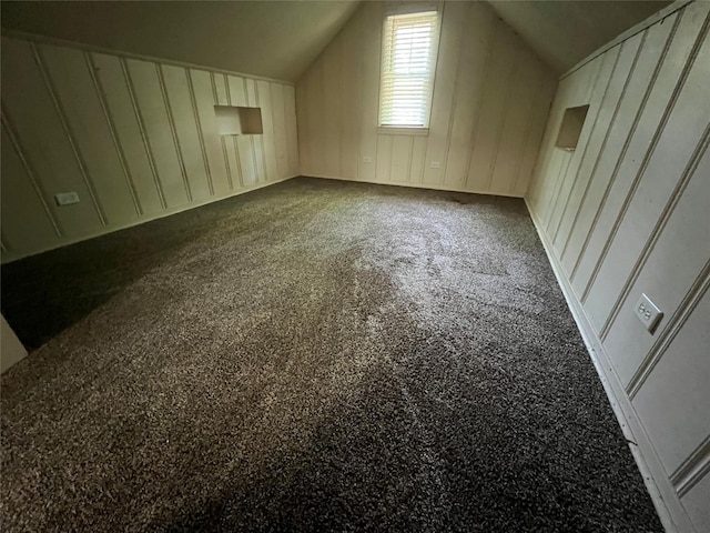 additional living space featuring lofted ceiling and carpet floors