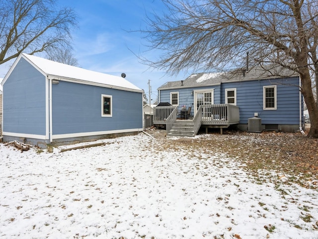 snow covered property with a deck