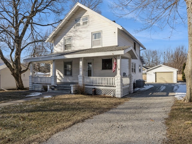 view of front of house featuring central air condition unit, an outbuilding, covered porch, a garage, and a front yard