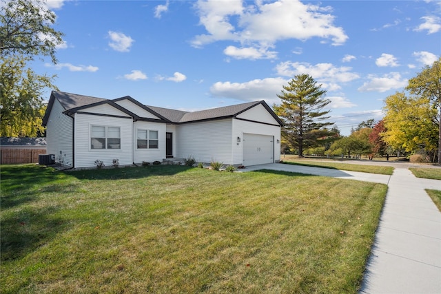 view of front of home with a front yard, central AC, and a garage