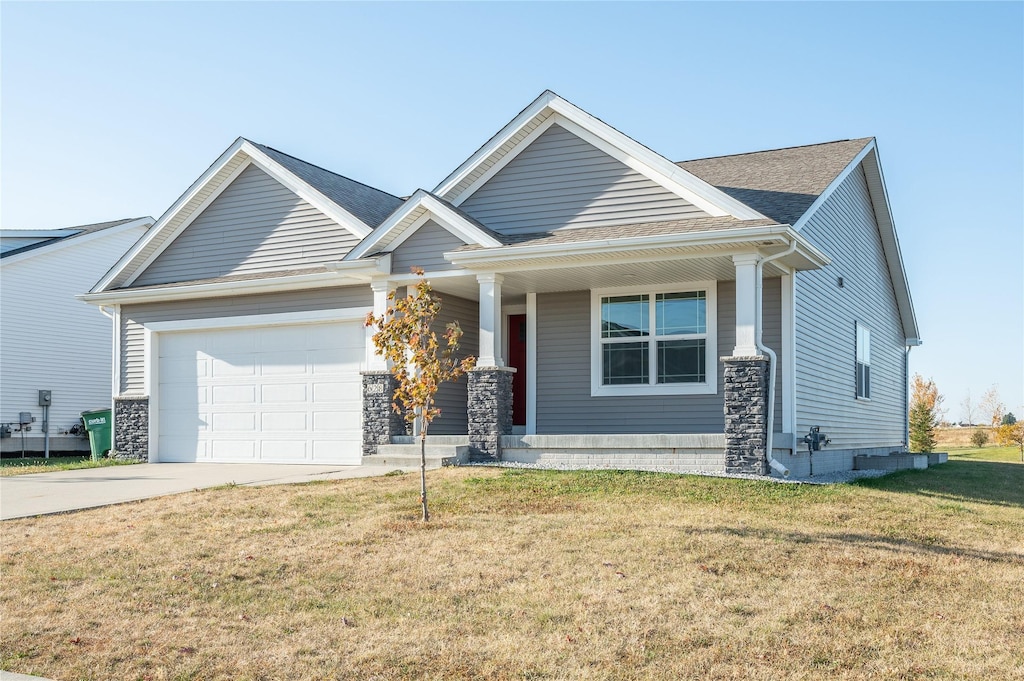 craftsman-style home featuring a front yard and a garage