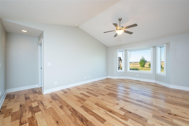 spare room featuring light hardwood / wood-style flooring, ceiling fan, and lofted ceiling