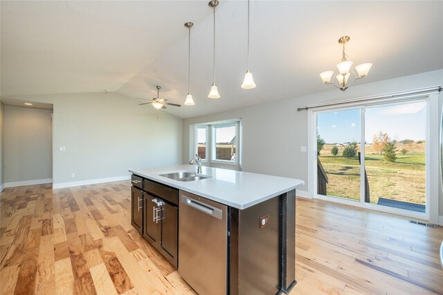 kitchen featuring dishwasher, ceiling fan with notable chandelier, sink, hanging light fixtures, and an island with sink