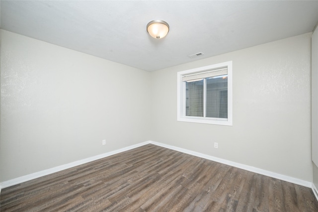 unfurnished room featuring dark hardwood / wood-style flooring