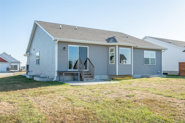 rear view of property featuring a lawn