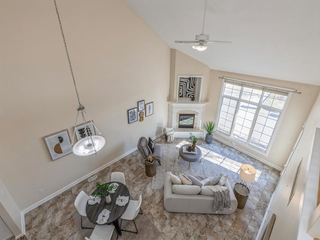 living room featuring ceiling fan and vaulted ceiling