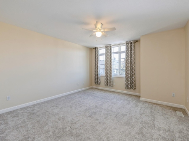 empty room featuring light carpet and ceiling fan