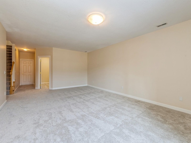 unfurnished room featuring light carpet