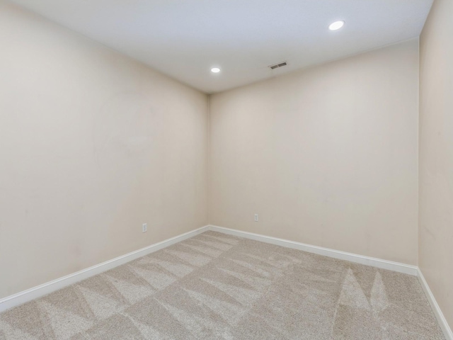 unfurnished room with light colored carpet