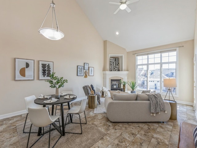 living room with ceiling fan and high vaulted ceiling