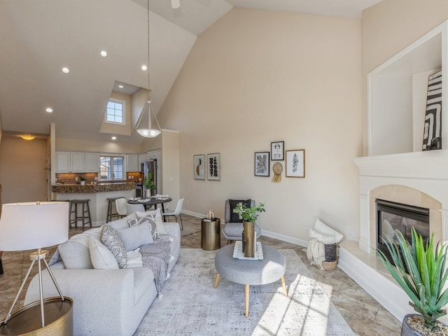 living room featuring a tile fireplace and high vaulted ceiling