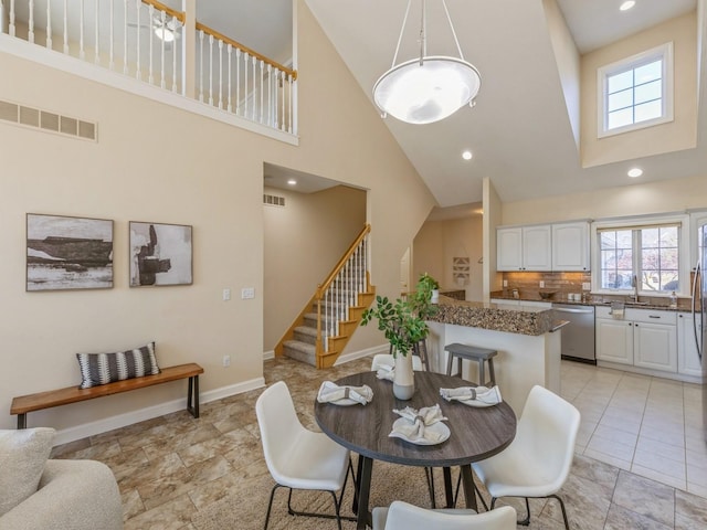 dining space with a towering ceiling