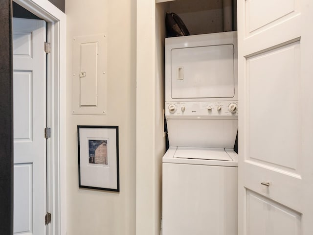 washroom with electric panel and stacked washing maching and dryer