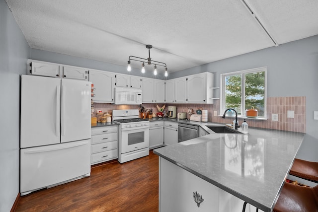 kitchen featuring sink, white cabinets, backsplash, kitchen peninsula, and white appliances