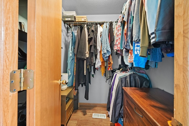 spacious closet featuring light hardwood / wood-style floors