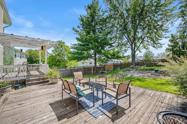 wooden deck with a pergola and a lawn