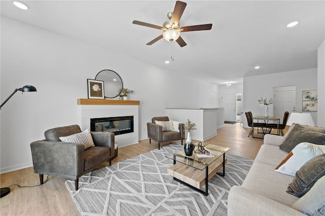 living room with ceiling fan and light wood-type flooring