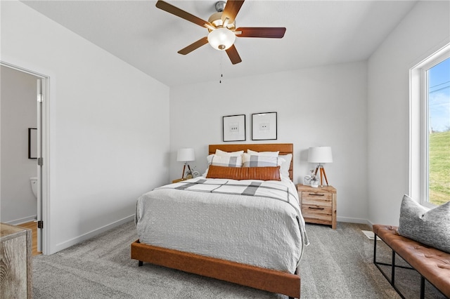 carpeted bedroom with connected bathroom and ceiling fan