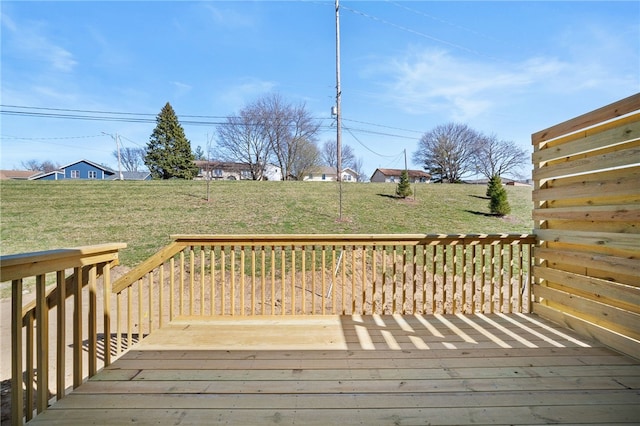 wooden deck featuring a lawn