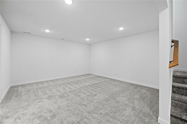 below grade area with recessed lighting, baseboards, carpet flooring, and stairs