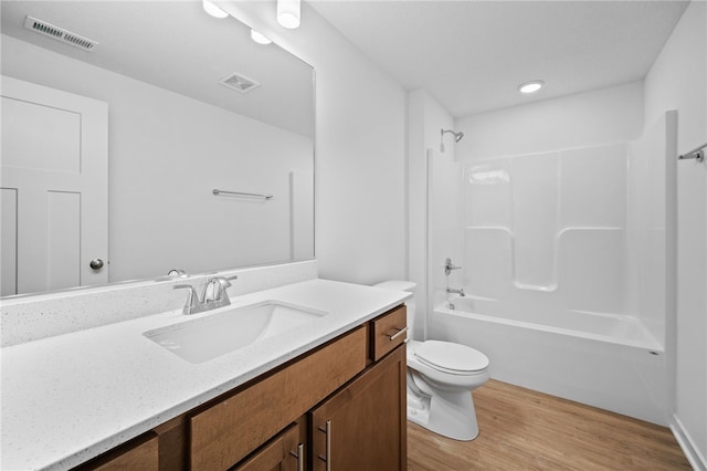 full bathroom with vanity, toilet, wood-type flooring, and shower / tub combination