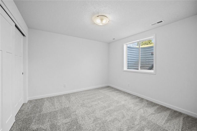 unfurnished bedroom with carpet flooring and a closet