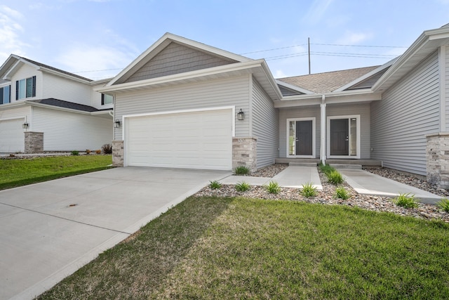 view of front of property with a garage, a front lawn, and concrete driveway