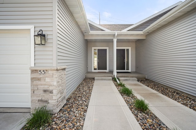 property entrance featuring roof with shingles