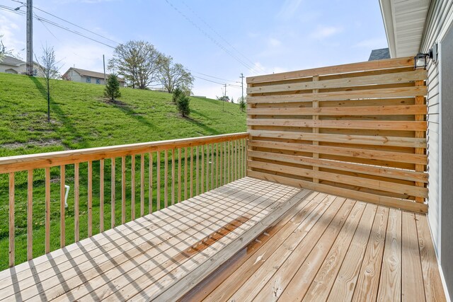 wooden deck featuring a yard
