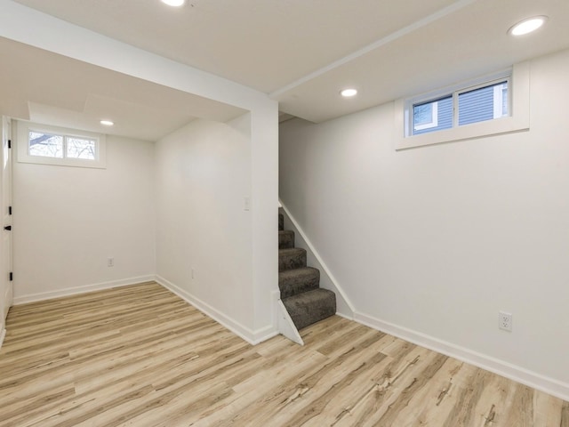 basement with light hardwood / wood-style flooring