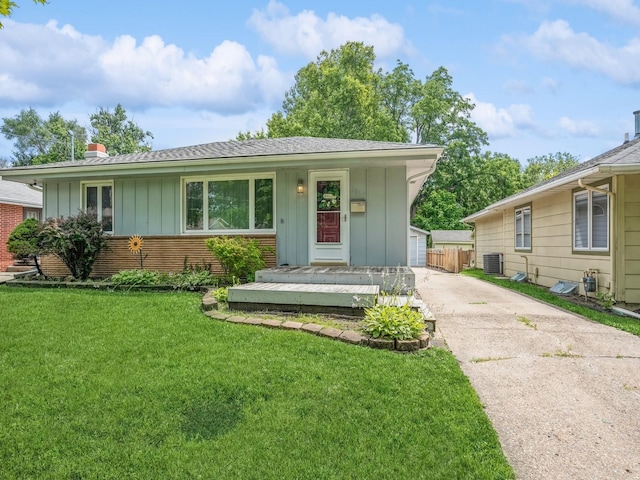 view of front of house with central air condition unit and a front yard